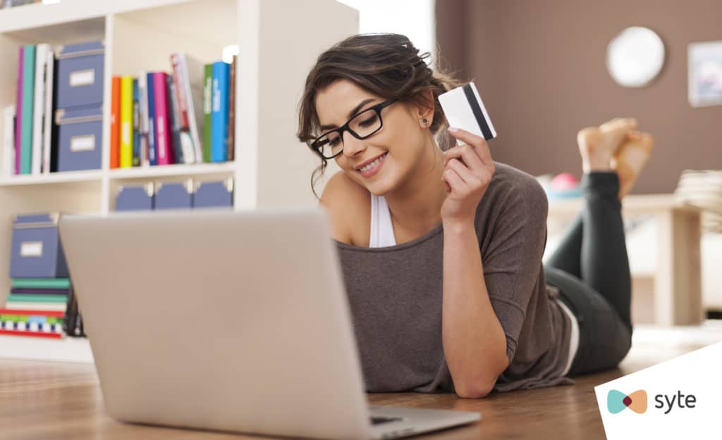 Woman prepares to lock in her eCommerce purchase with her credit card. 