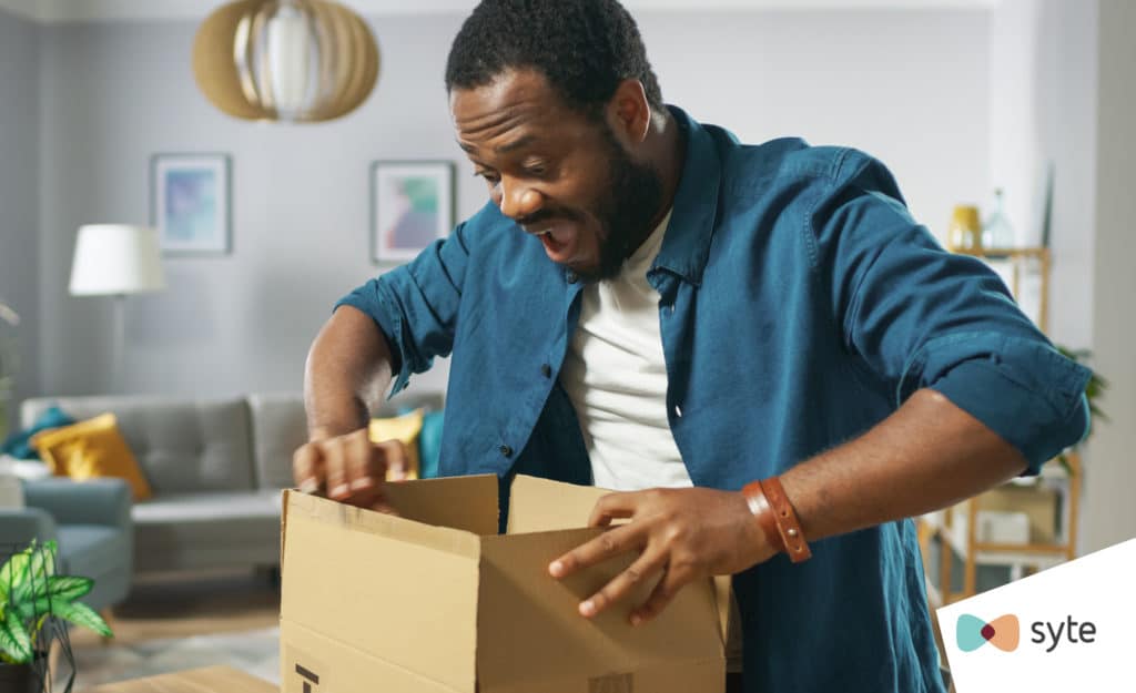 Man searches inside a box from his most recent eCommerce purchase. 