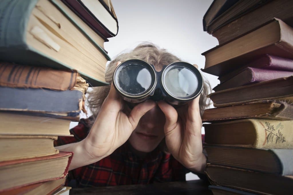 man using binoculars to search