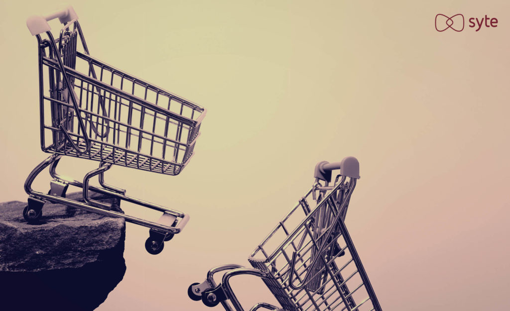 Two shopping carts fall off a cliff representing online cart abandonment. 