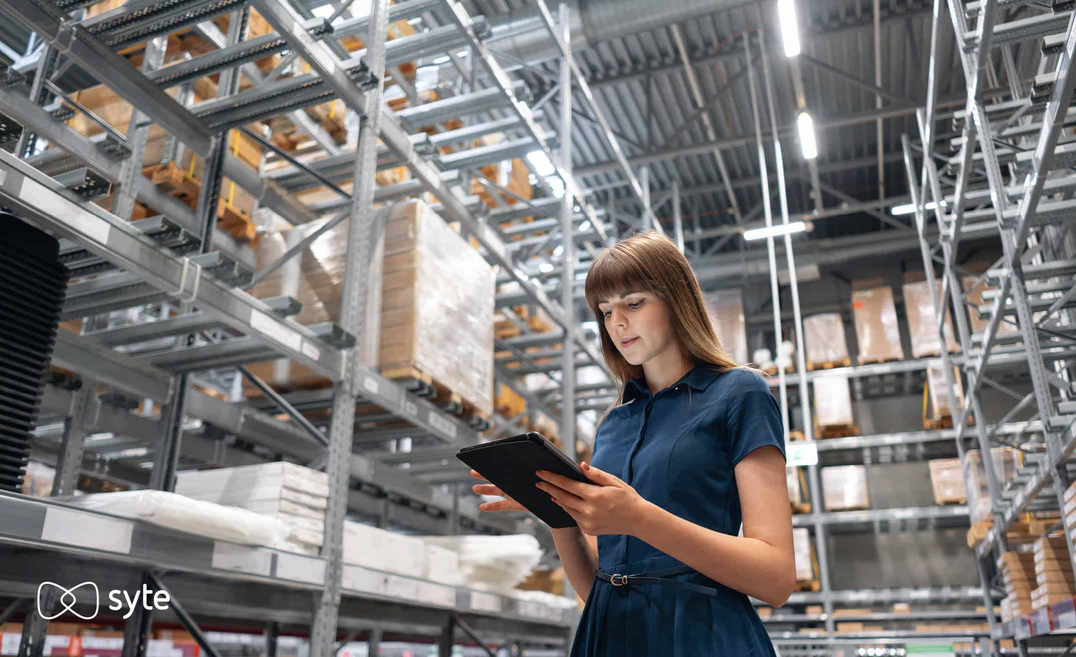 A woman checks inventory in a warehouse ahead of Black Friday