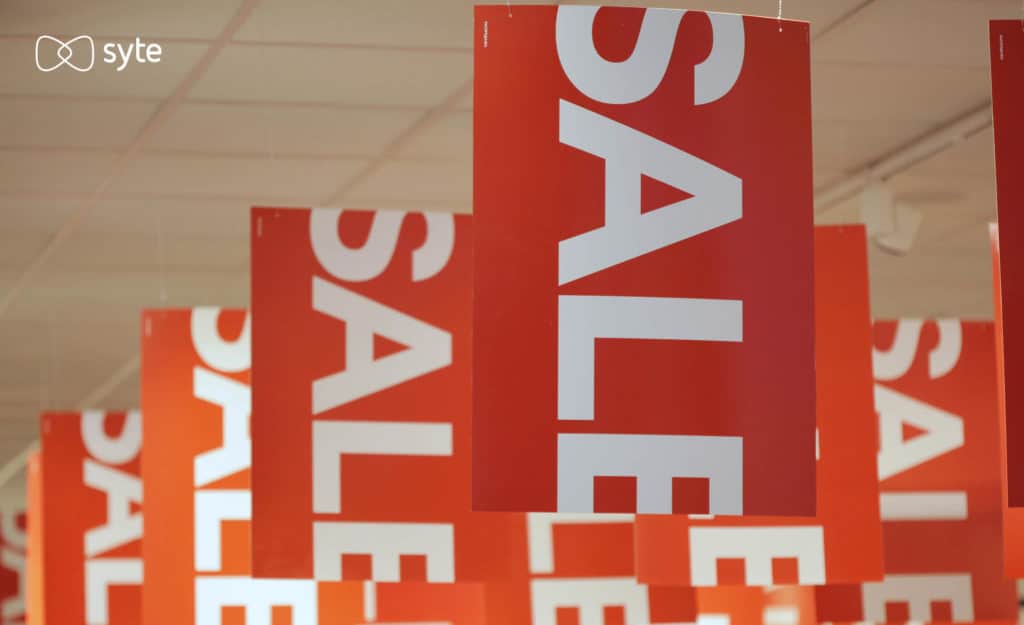 sale signs hang from ceiling in a retail store