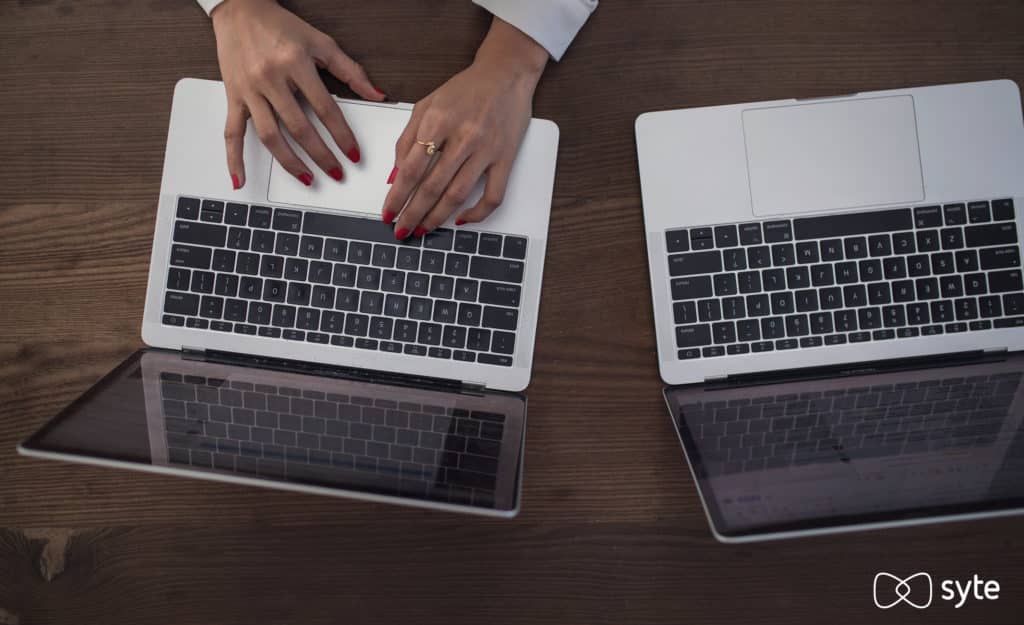 A photo of two laptops to represent eCommerce replatforming