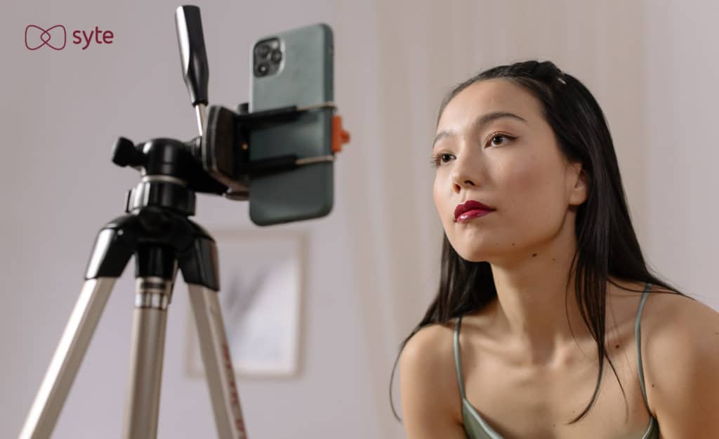 Woman looks into camera while livestreaming her new Singles Day look. 