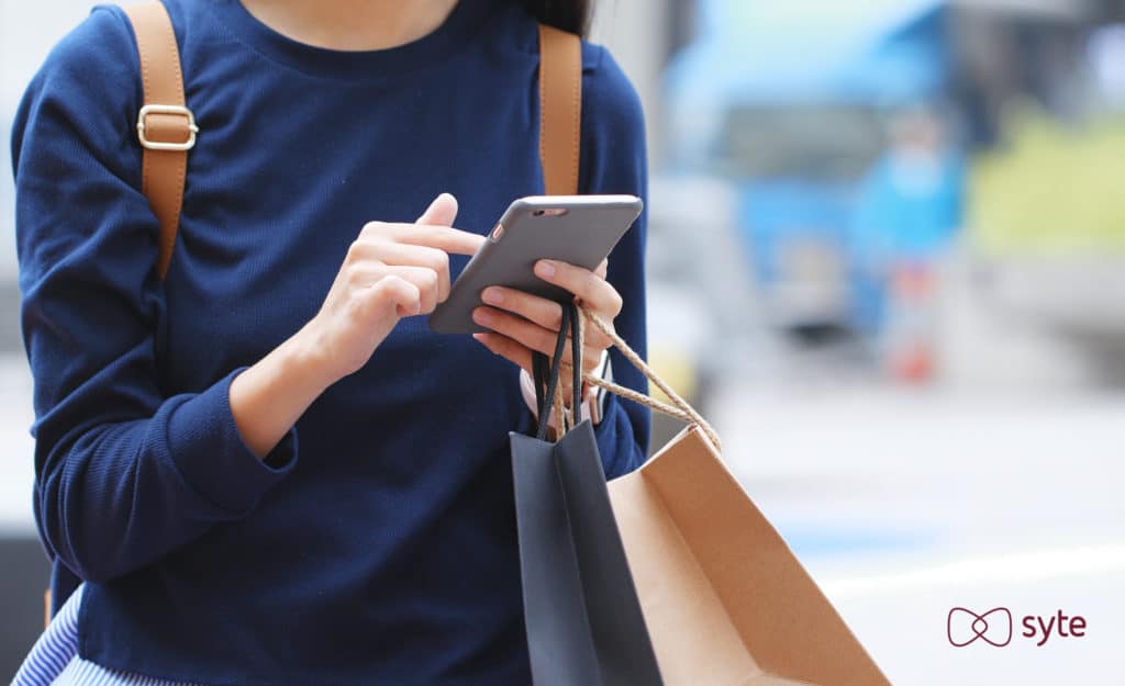 Woman with phone and shopping bags 