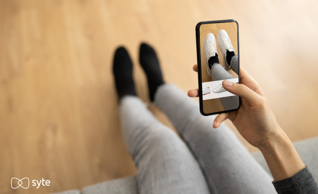 Woman uses aumented reality app to virtually try on shoes