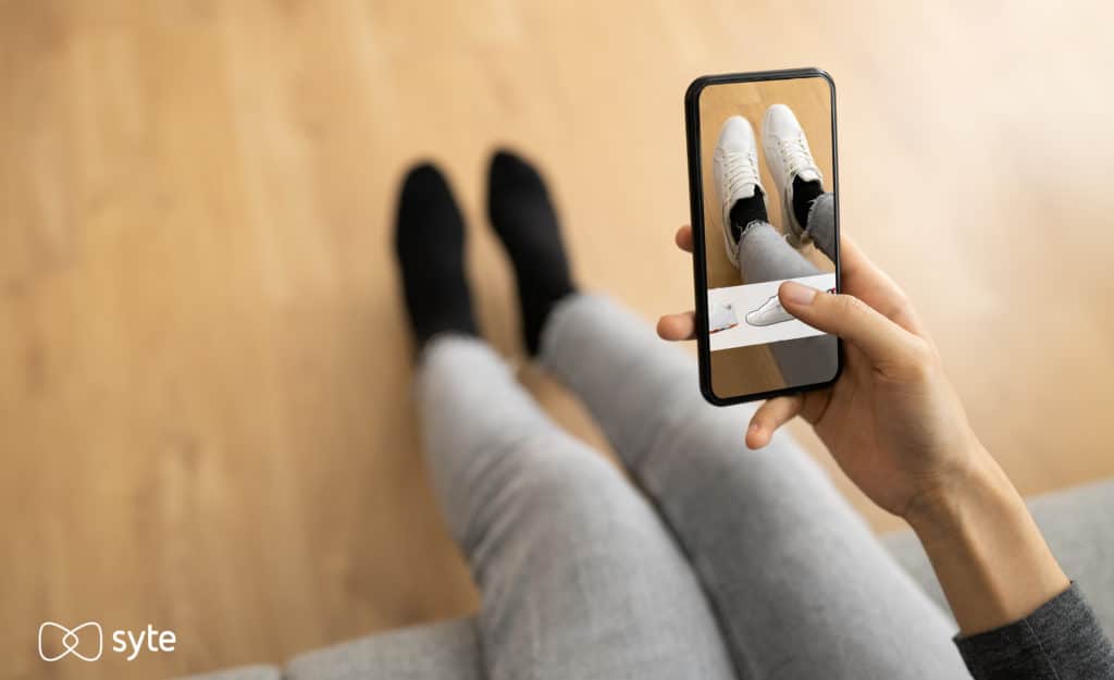 Woman uses aumented reality app to virtually try on shoes