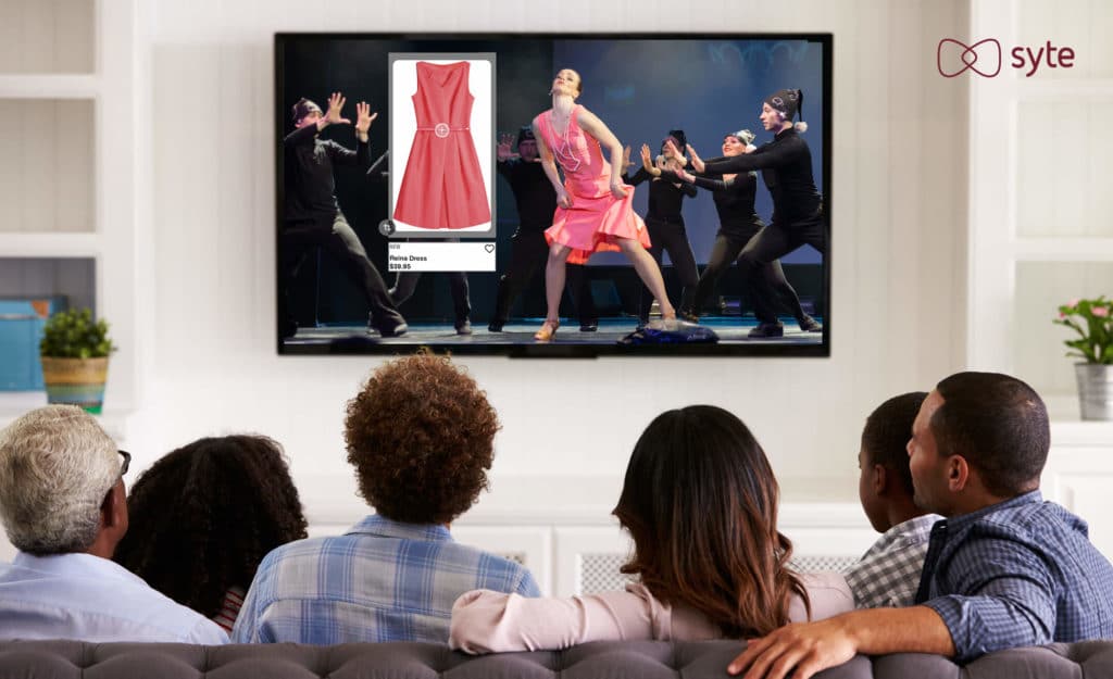 A television shows an actress with a shoppable dress, illustrating the future of shopping.