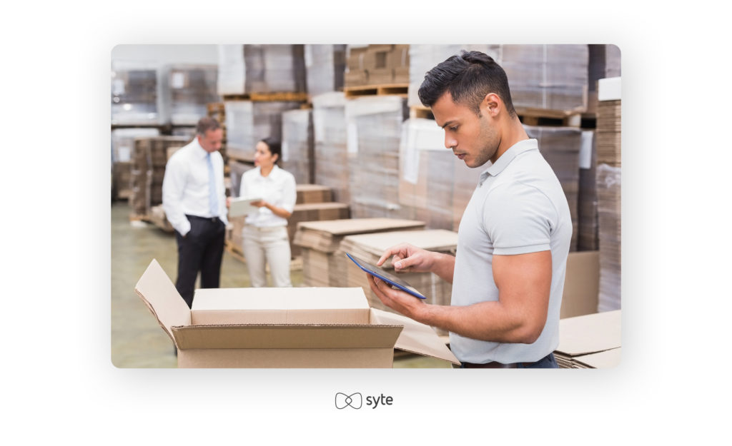 Male manager using a digital tablet in a warehouse.