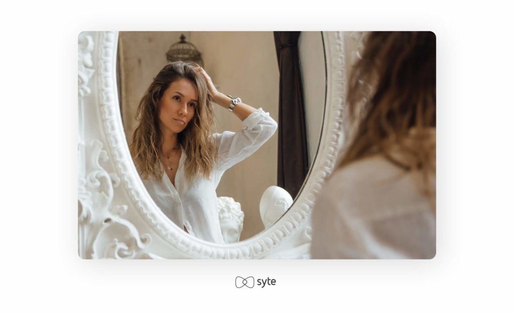 Woman looking into a mirror.
