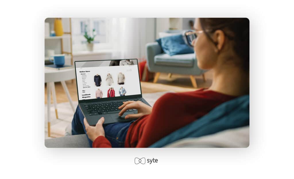 woman shopping online on her laptop from the couch at home