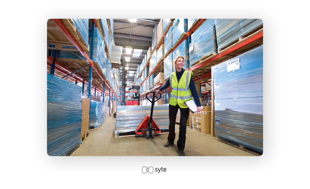 woman in warehouse moving inventory