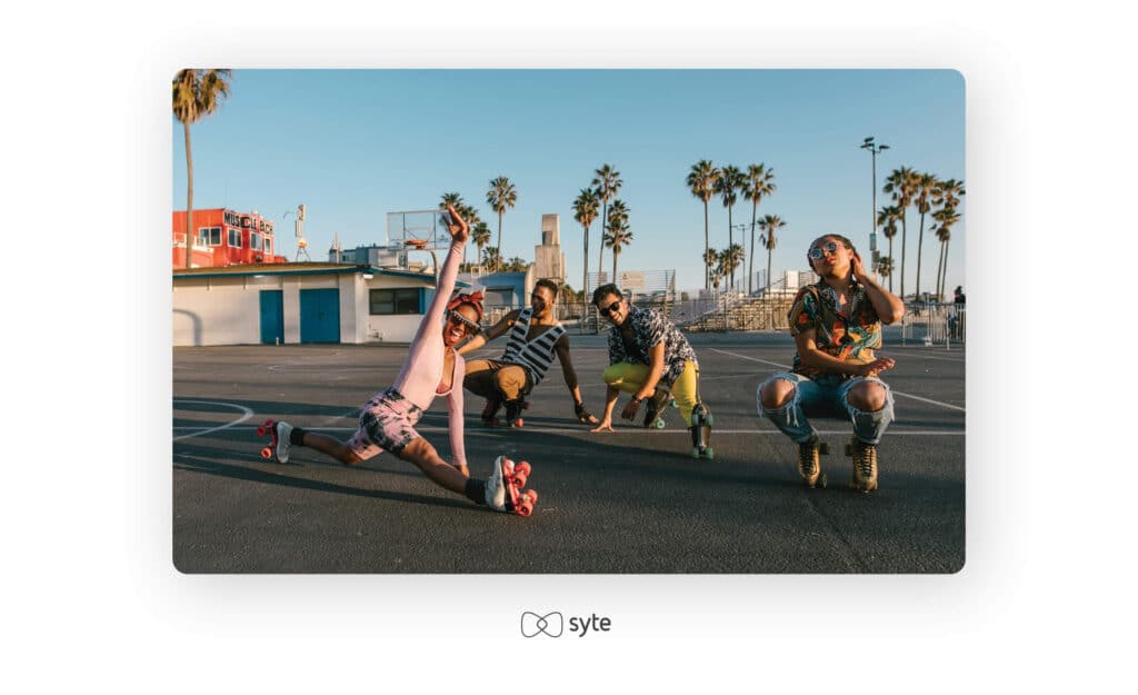 Group of friends rollerskating on an outdoor court.